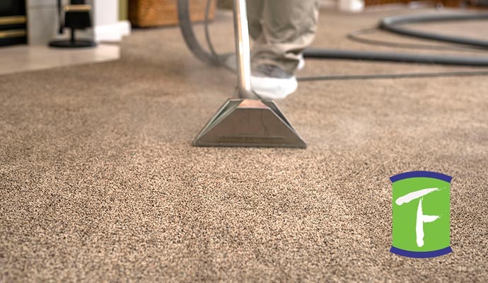 Professional worker cleanng old and dried carpet stain in Sarasota, FL
