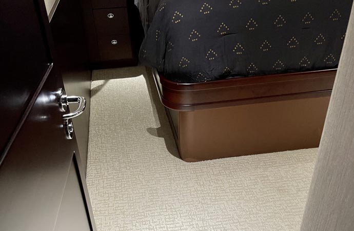 Cleaning the bedroom of a yacht with meticulous care
