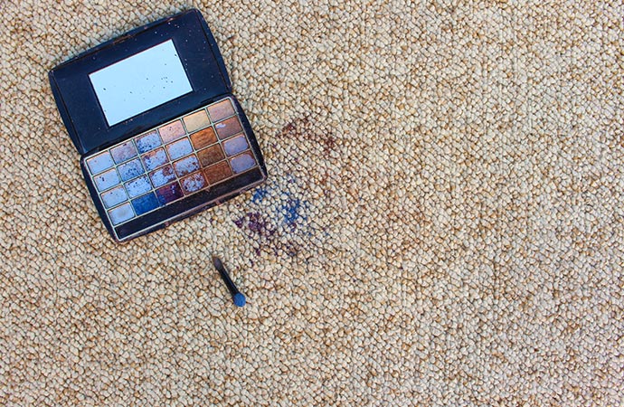 Eye shadow scattered on carpet.